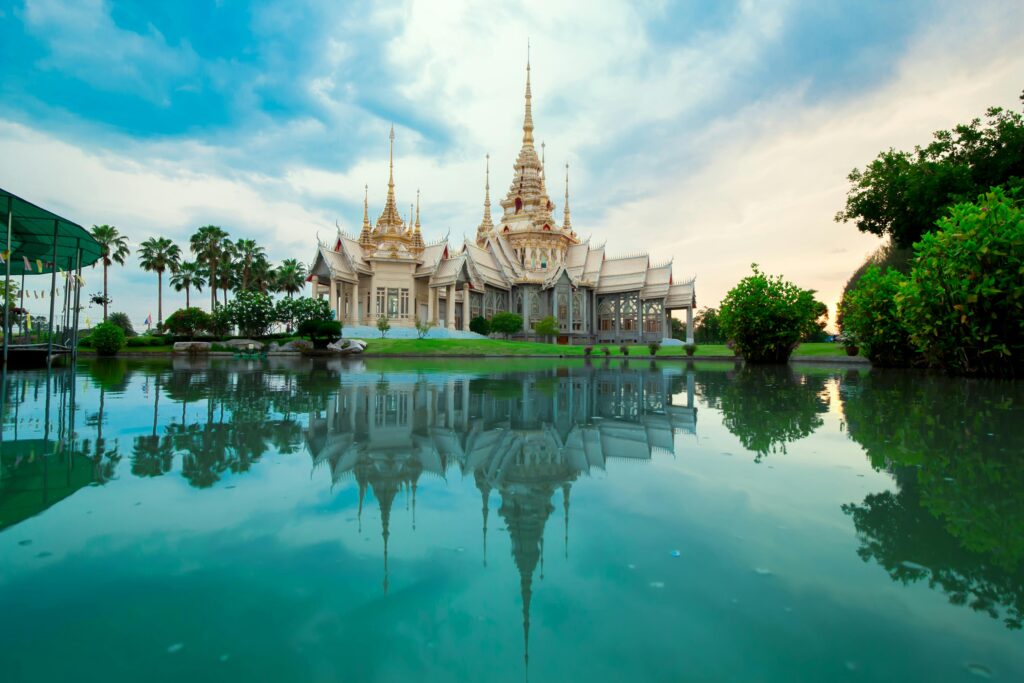 Beautiful Thai temple with serene reflection in water, showcasing spirituality and culture.